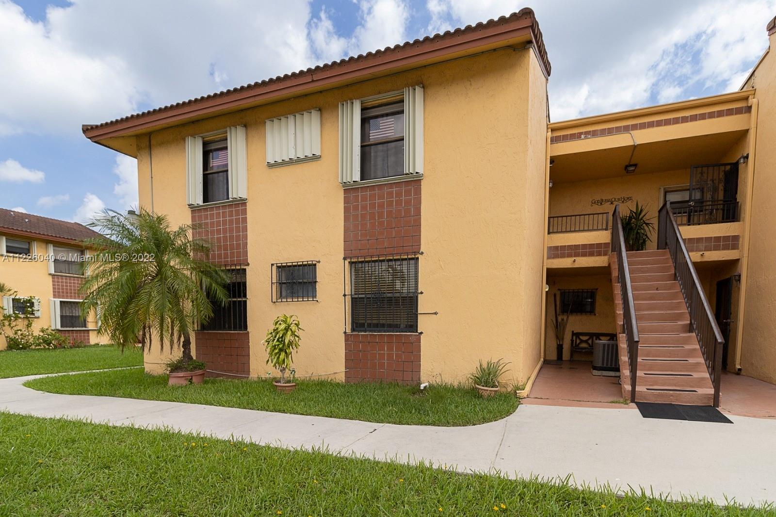 10897 Northwest 7th Street, Unit 1429 Miami, FL 33172 - Photo 1 of 17 a front view of a house with a yard