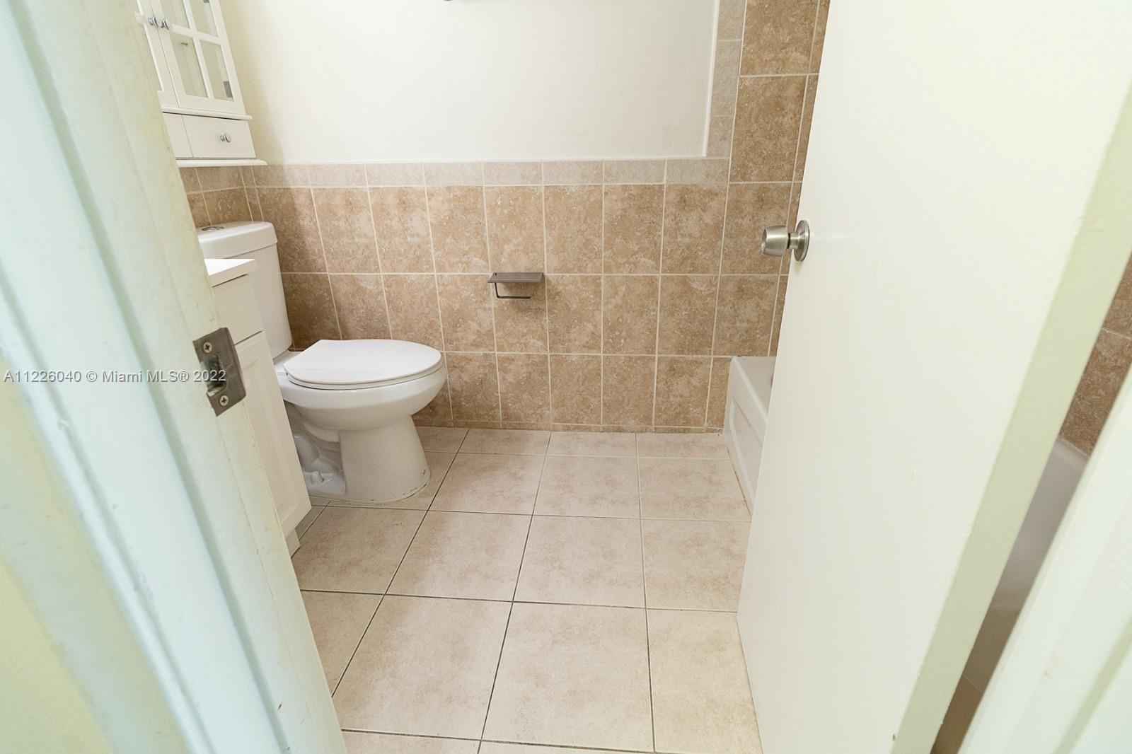 10897 Northwest 7th Street, Unit 1429 Miami, FL 33172 - Photo 13 of 17 a bathroom with a toilet and a shower