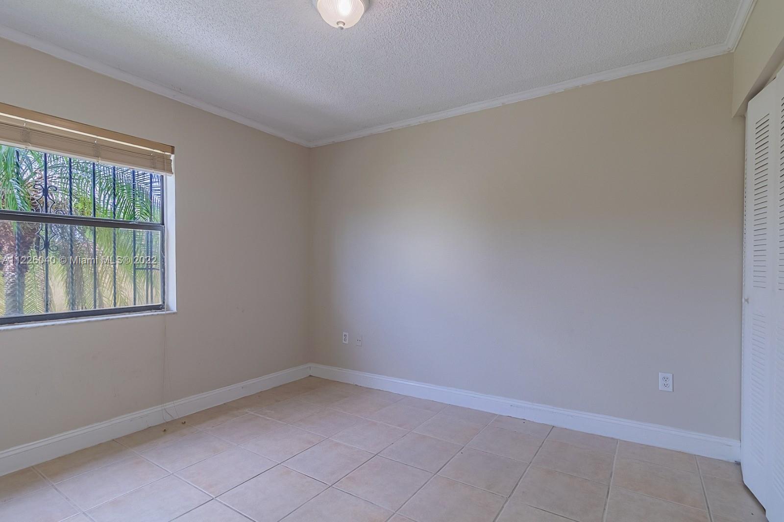 10897 Northwest 7th Street, Unit 1429 Miami, FL 33172 - Photo 14 of 17 an empty room with a window