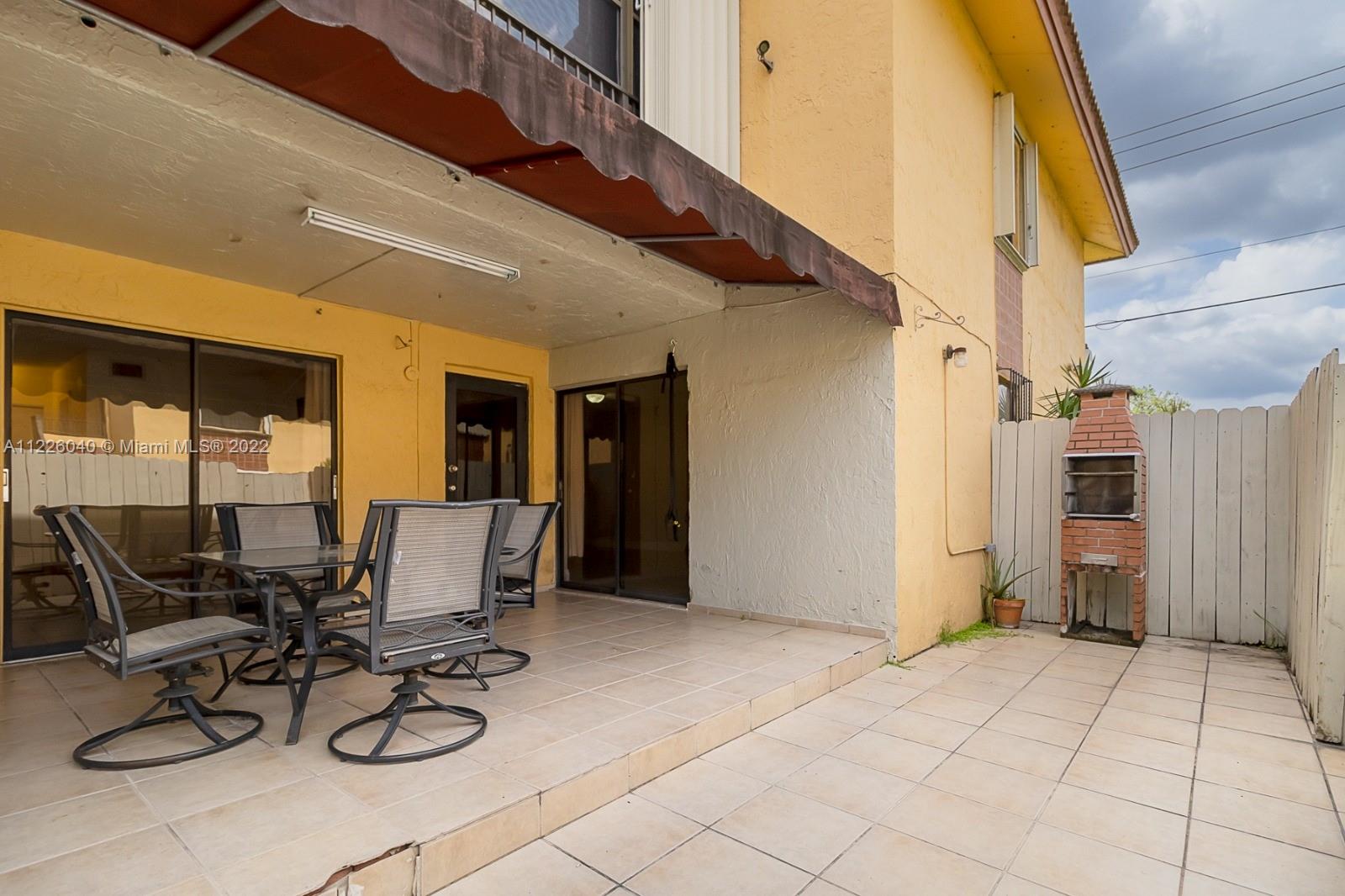 10897 Northwest 7th Street, Unit 1429 Miami, FL 33172 - Photo 17 of 17 a view of a patio with table and chairs and potted plants