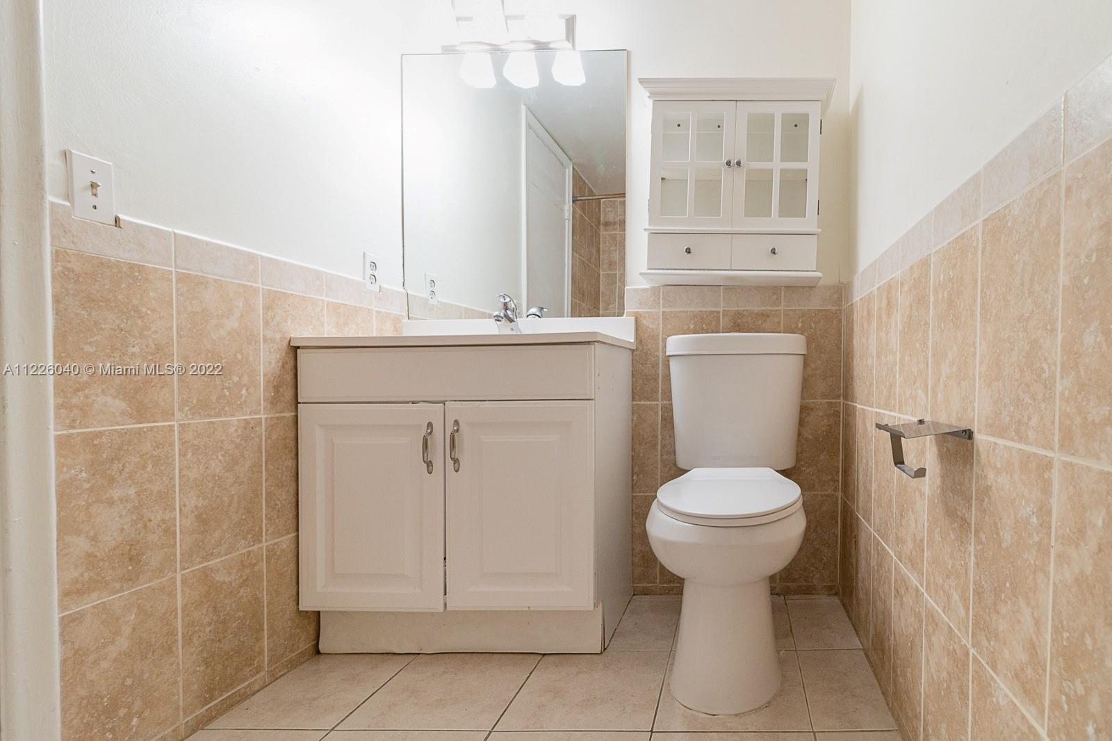 10897 Northwest 7th Street, Unit 1429 Miami, FL 33172 - Photo 8 of 17 a bathroom with a sink toilet and shower