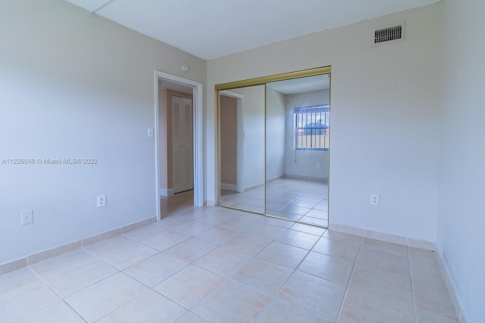 10897 Northwest 7th Street, Unit 1429 Miami, FL 33172 - Photo 9 of 17 a view of an empty room with closet and a bathroom