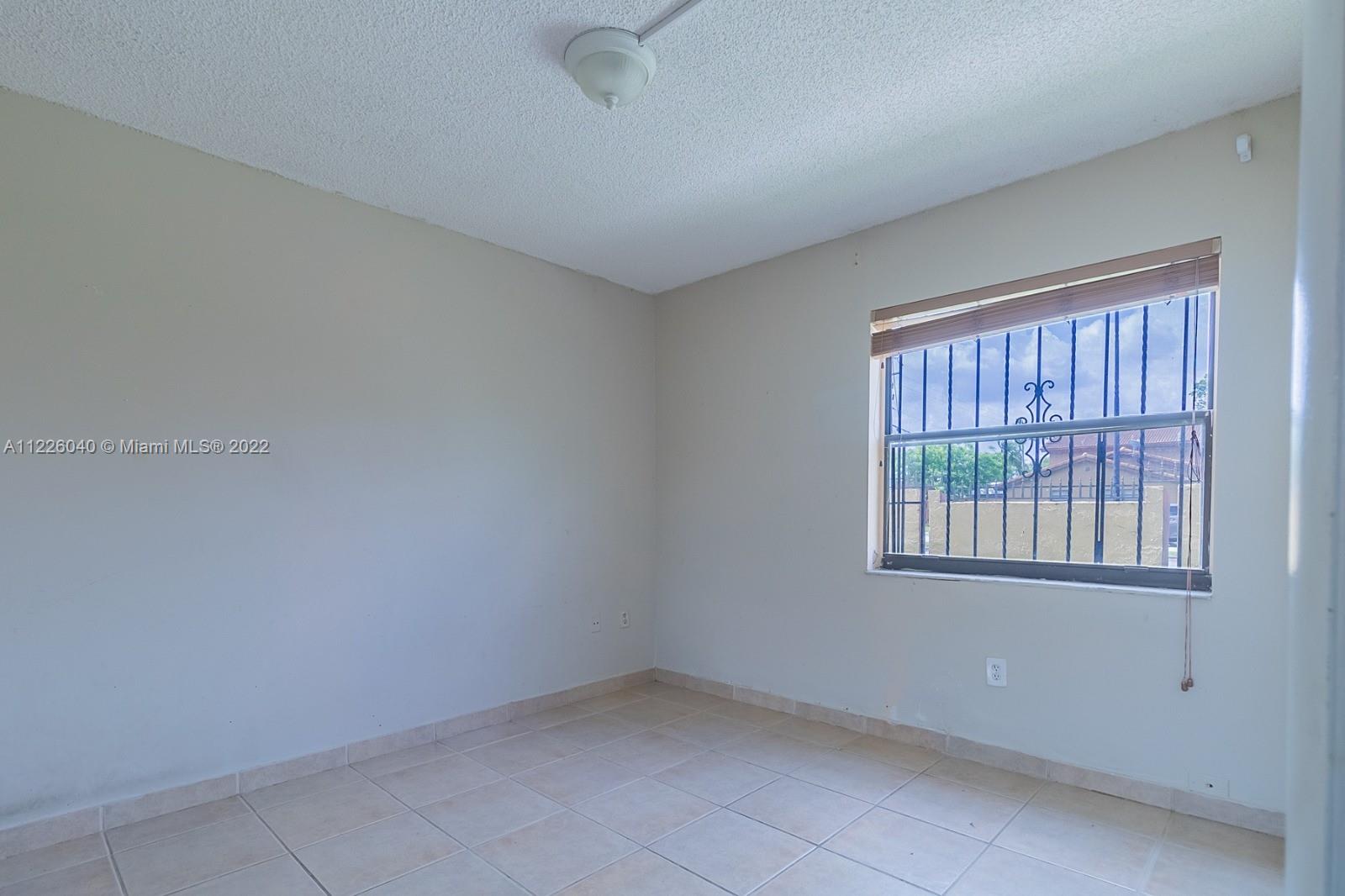 10897 Northwest 7th Street, Unit 1429 Miami, FL 33172 - Photo 10 of 17 a view of an empty room with a window