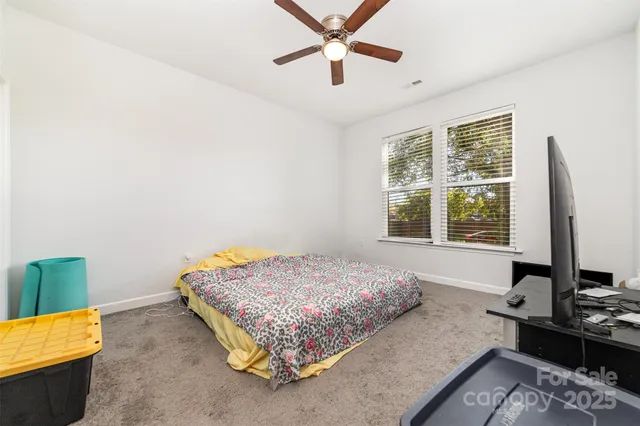 a bedroom with a bed window and flat screen tv