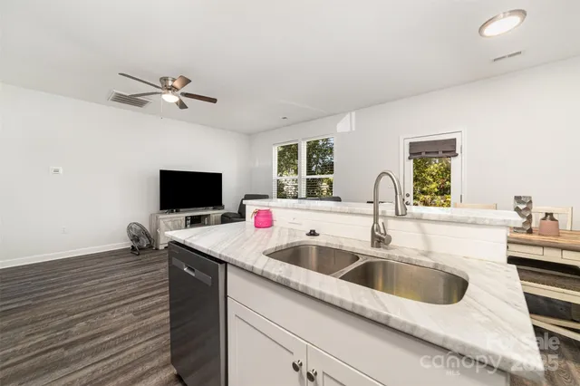 a kitchen with a sink and a stove top oven