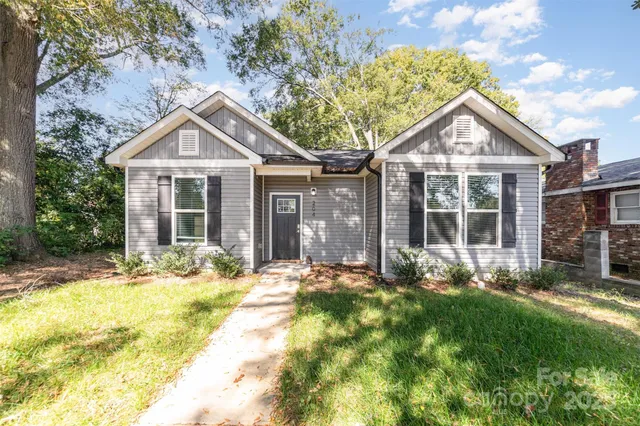 a front view of a house with a yard and porch