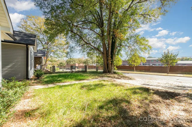 a view of yard with swimming pool and trees