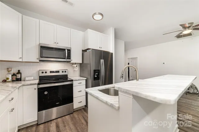 a kitchen with a sink stove and refrigerator