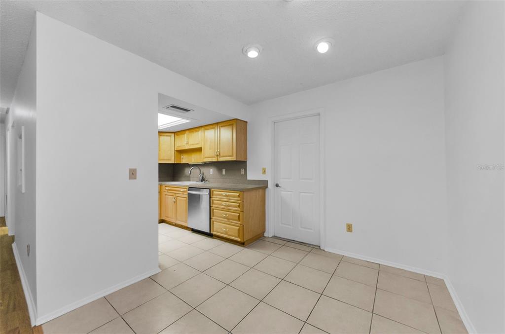 2836 Highlands Boulevard, Unit A Palm Harbor, FL 34684 - Photo 12 of 95 a kitchen with a sink a stove top oven a counter space and cabinets