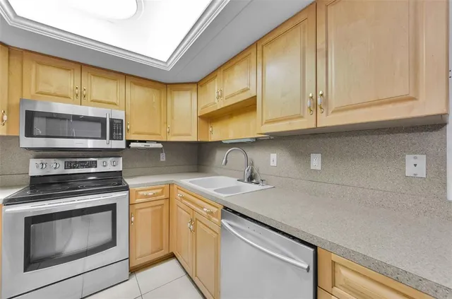 a kitchen with stainless steel appliances granite countertop a sink and cabinets