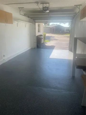 a view of a street with a cars parked and a small yard