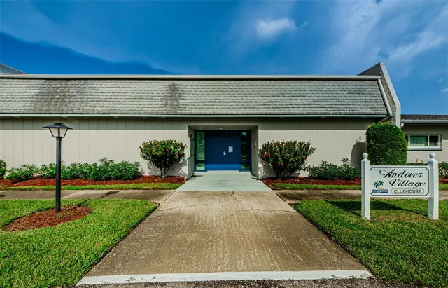 a view of a swimming pool with a patio and a yard