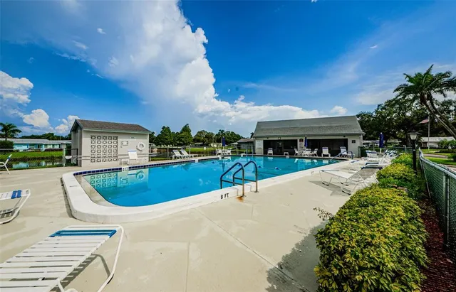 a view of a swimming pool with a patio and a garden