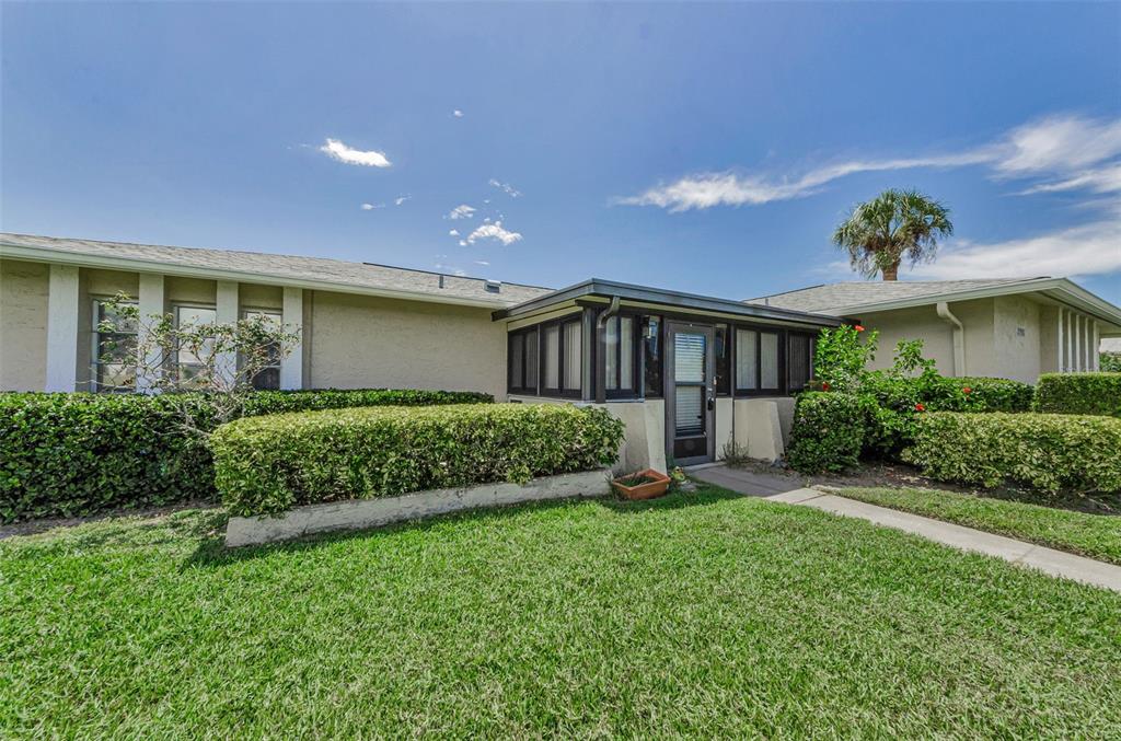 2836 Highlands Boulevard, Unit A Palm Harbor, FL 34684 - Photo 6 of 95 a front view of a house with a garden