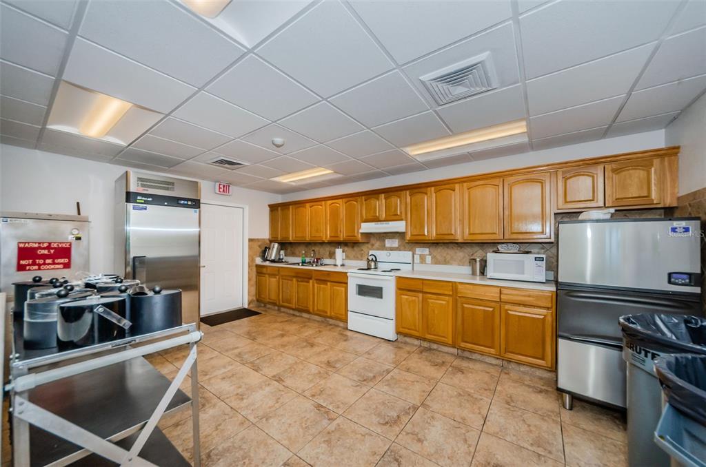2836 Highlands Boulevard, Unit A Palm Harbor, FL 34684 - Photo 77 of 95 a kitchen with stainless steel appliances granite countertop a stove a sink dishwasher and a refrigerator