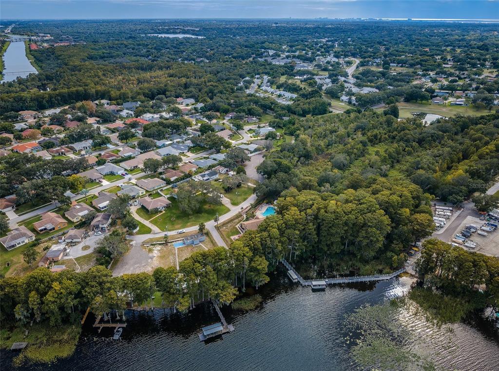 2836 Highlands Boulevard, Unit A Palm Harbor, FL 34684 - Photo 86 of 95 an aerial view of a houses with a street and trees