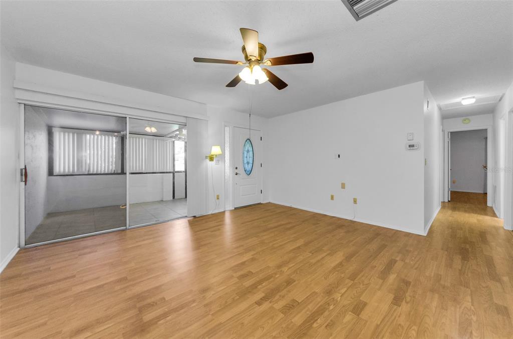 2836 Highlands Boulevard, Unit A Palm Harbor, FL 34684 - Photo 9 of 95 a view of empty room with wooden floor and fan