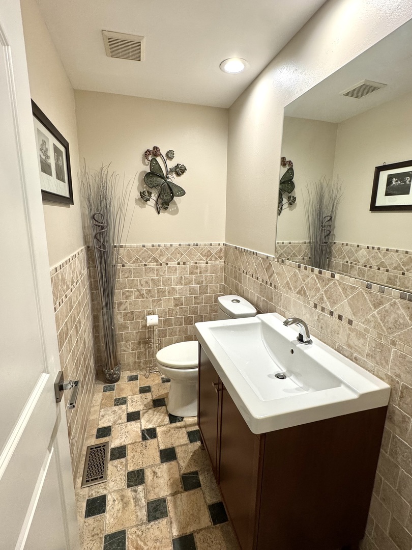 1009 Arbor Court Mount Prospect, IL 60056 - Photo 14 of 35 a bathroom with a sink and a mirror