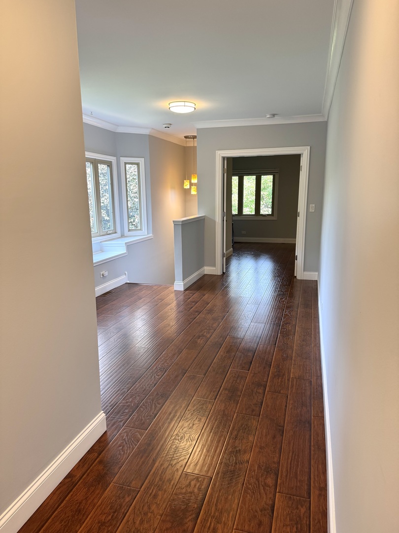 1009 Arbor Court Mount Prospect, IL 60056 - Photo 16 of 35 wooden floor in an empty room with a window