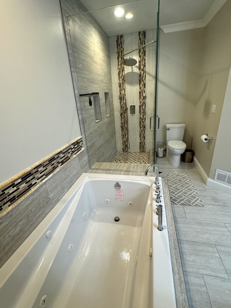 1009 Arbor Court Mount Prospect, IL 60056 - Photo 22 of 35 a bathroom with a tub a toilet and a shower