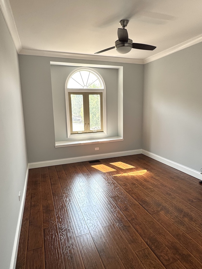 1009 Arbor Court Mount Prospect, IL 60056 - Photo 26 of 35 wooden floor in an empty room with a window