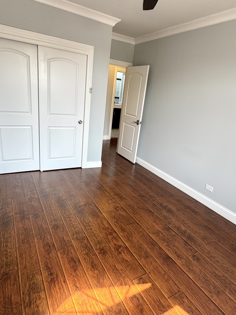 1009 Arbor Court Mount Prospect, IL 60056 - Photo 27 of 35 a view of a livingroom with wooden floor and closet