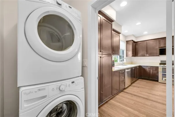 a large kitchen with a sink a washer and dryer