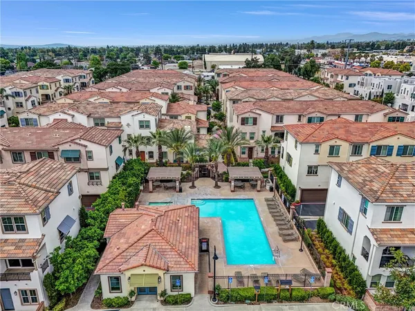 an aerial view of multiple houses with a yard