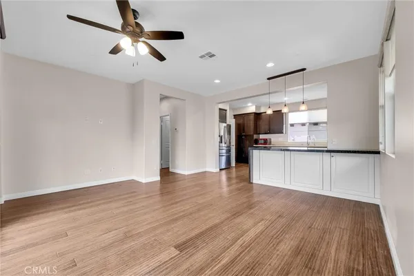 a view of kitchen with stainless steel appliances refrigerator stove microwave and cabinets