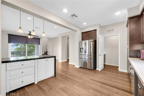 a kitchen with refrigerator and cabinets