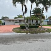 a house with palm tree in front of it
