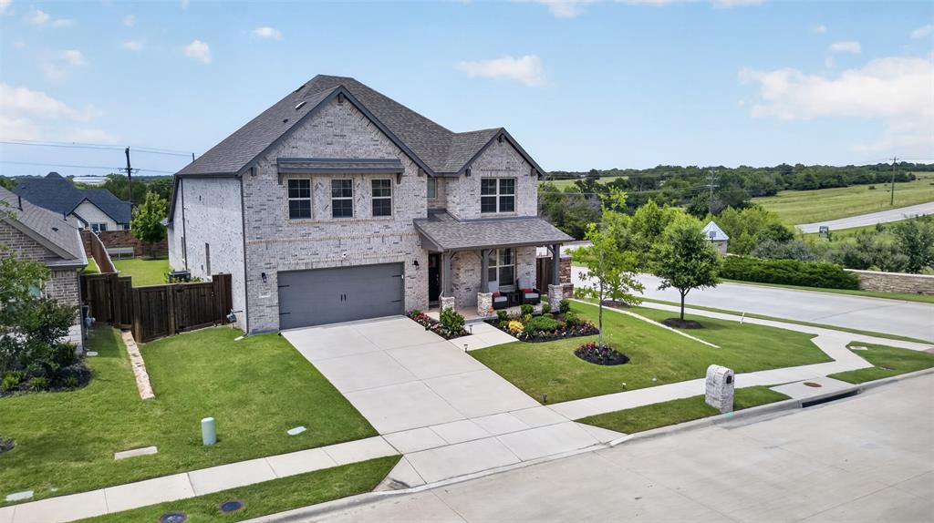 1002 Coppersmith Way Forney, TX 75126 - Photo 24 of 39 a front view of a house with garden