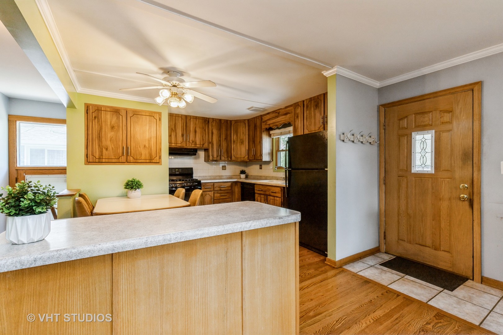 1504 Ridgeway Street Round Lake Beach, IL 60073 - Photo 8 of 19 a kitchen with granite countertop a refrigerator a sink a stove a dining table and chairs