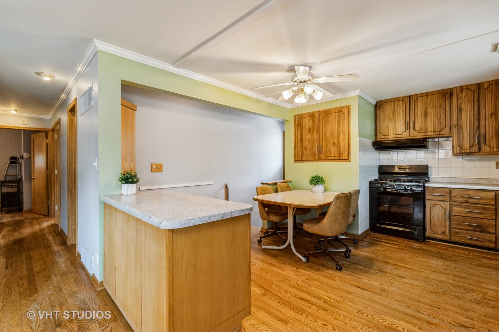 1504 Ridgeway Street Round Lake Beach, IL 60073 - Photo 9 of 19 a kitchen with a stove a sink a dining table and chairs