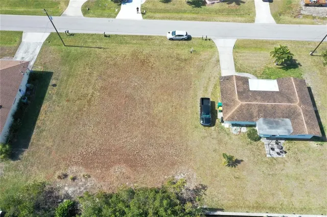 an aerial view of a house with a yard basket ball court and outdoor seating