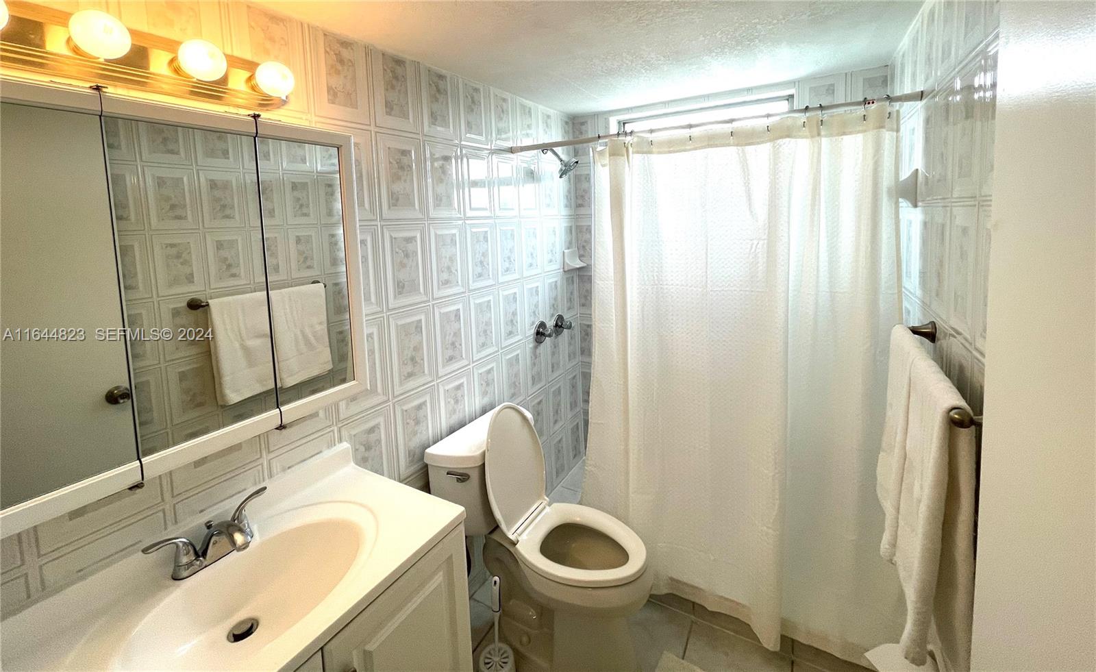 3075 Northwest 7th Street, Unit 302 Miami, FL 33125 - Photo 6 of 6 a bathroom with a sink toilet and shower