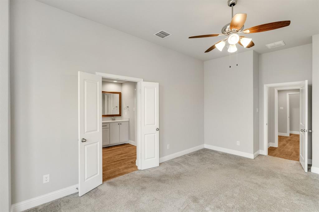 915 Timber Ridge Drive Justin, TX 76247 - Photo 20 of 39 Neutral gray walls complement the gray carpeting