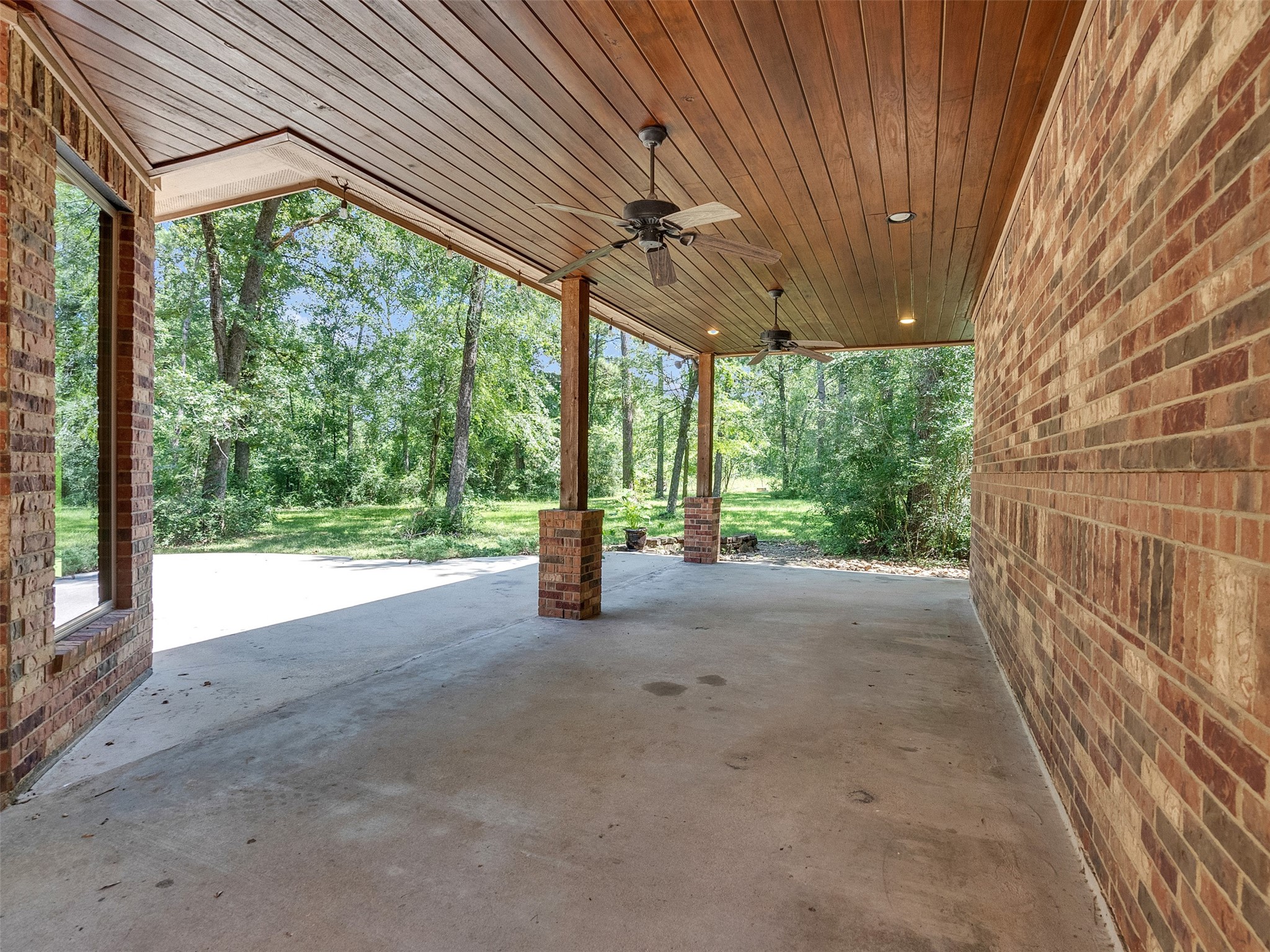 28503 Champions Ridge Road Magnolia, TX 77354 - Photo 41 of 47 Enjoy a spacious back patio, perfect for gatherings, barbecues, or simply enjoying the serene surroundings.