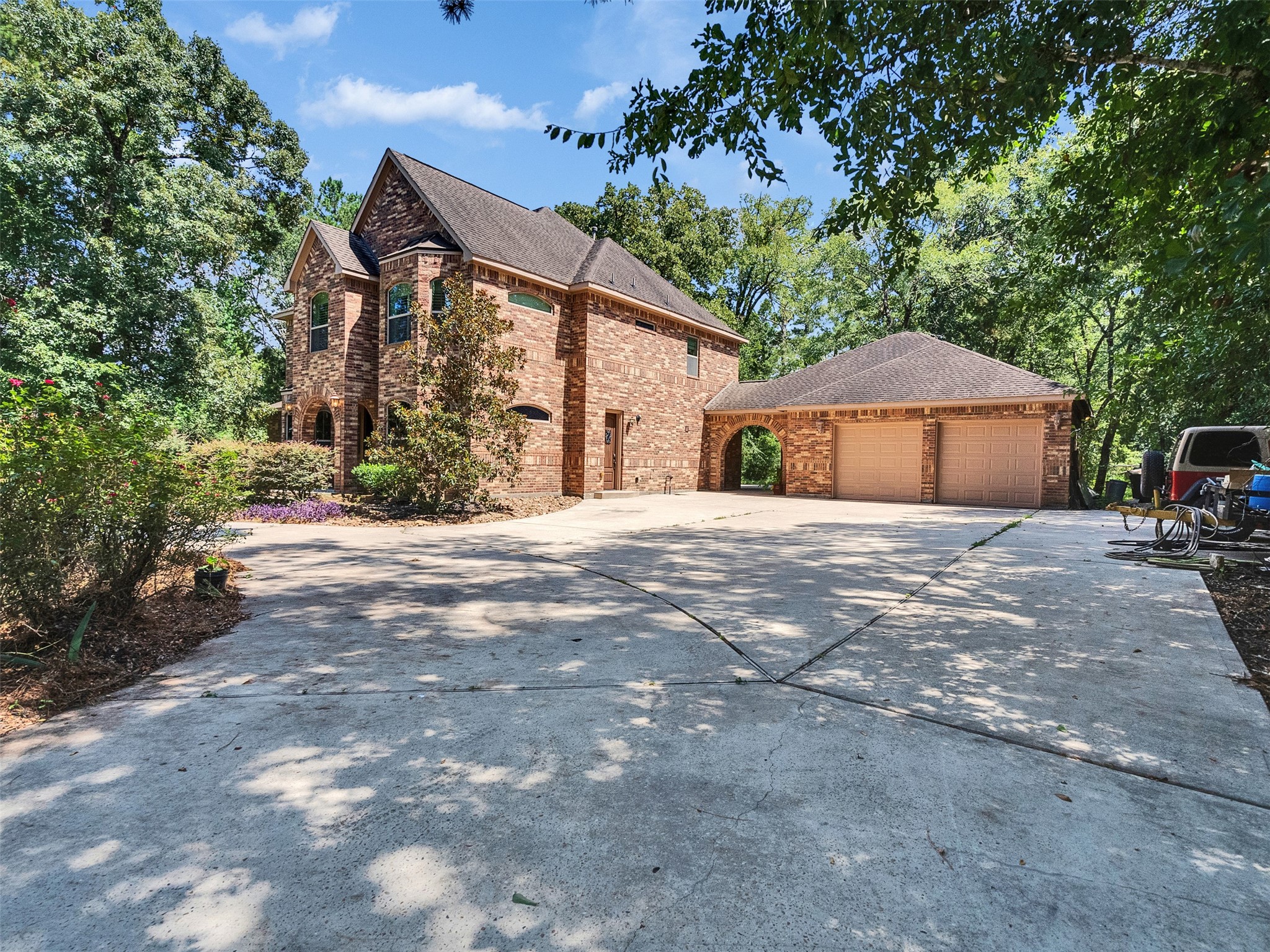 28503 Champions Ridge Road Magnolia, TX 77354 - Photo 43 of 47 The drive-through driveway provides ample parking space for multiple vehicles and easy access in and out.
