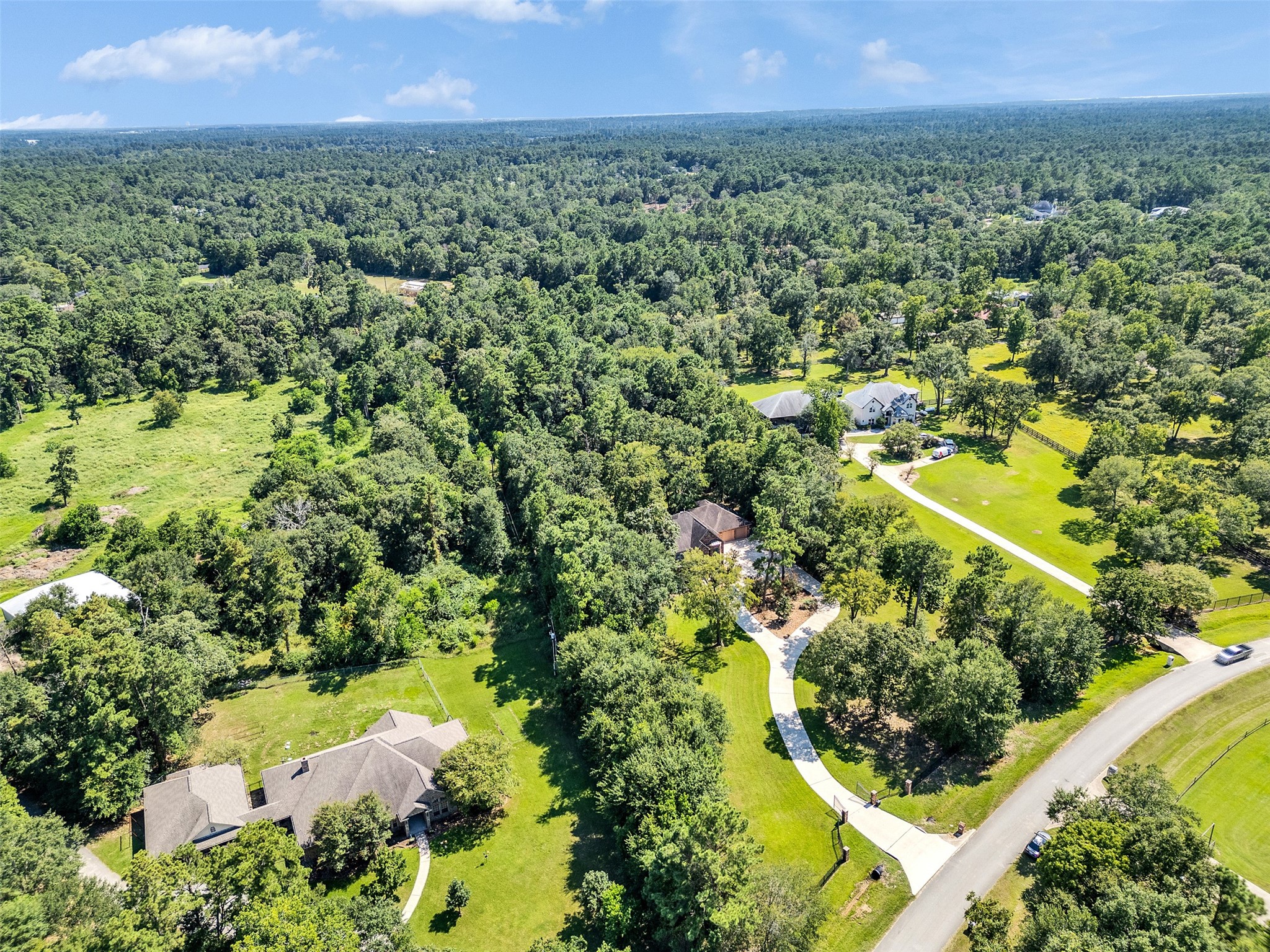 28503 Champions Ridge Road Magnolia, TX 77354 - Photo 45 of 47 Surrounded by 5 acres of lush land, this home provides a retreat-like atmosphere, perfect for relaxing, entertaining, and enjoying nature.