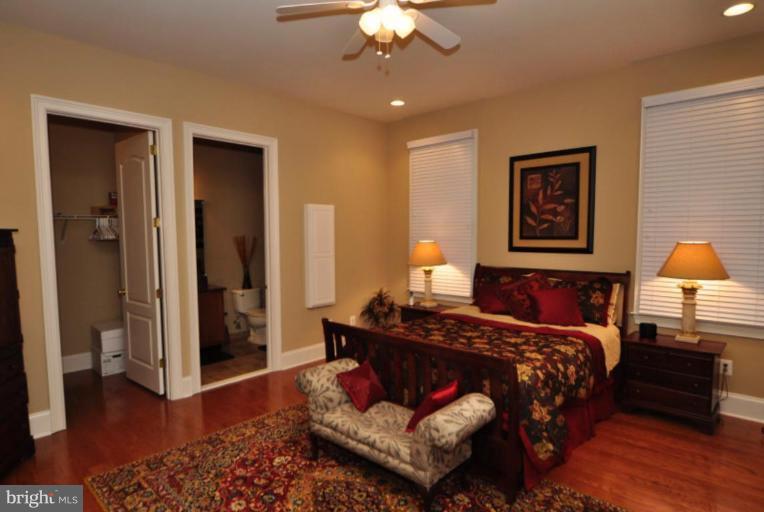 20129 Black Diamond Place Ashburn, VA 20147 - Photo 13 of 20 a bedroom with a bed and a chandelier