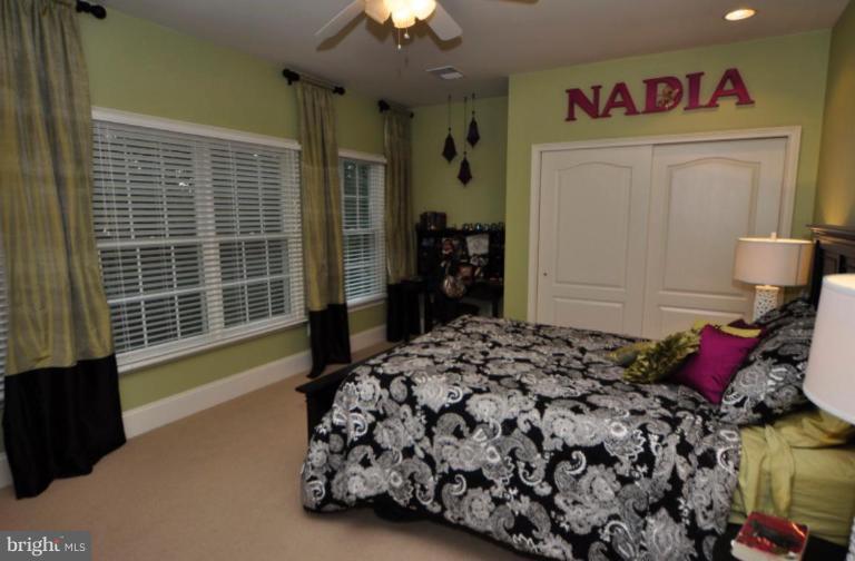 20129 Black Diamond Place Ashburn, VA 20147 - Photo 17 of 20 a bedroom with a bed and a window