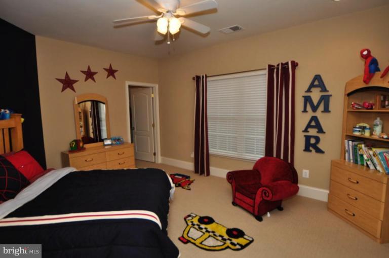 20129 Black Diamond Place Ashburn, VA 20147 - Photo 19 of 20 a bedroom with a bed and a window