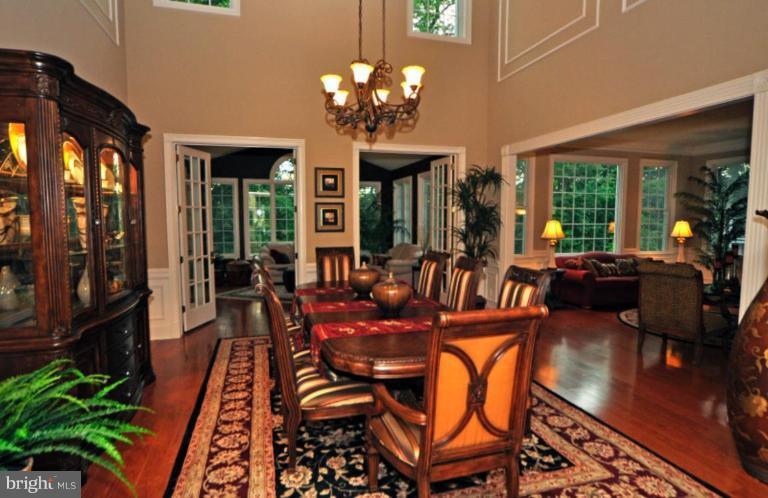20129 Black Diamond Place Ashburn, VA 20147 - Photo 4 of 20 a view of a dining room with furniture a chandelier and wooden floor