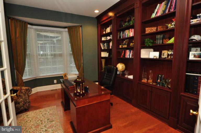 20129 Black Diamond Place Ashburn, VA 20147 - Photo 7 of 20 a living room with furniture a bookshelf and a window