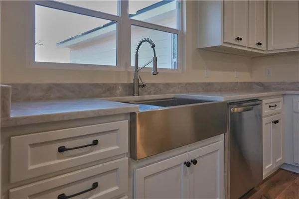 a close view of a sink and a stove in a kitchen