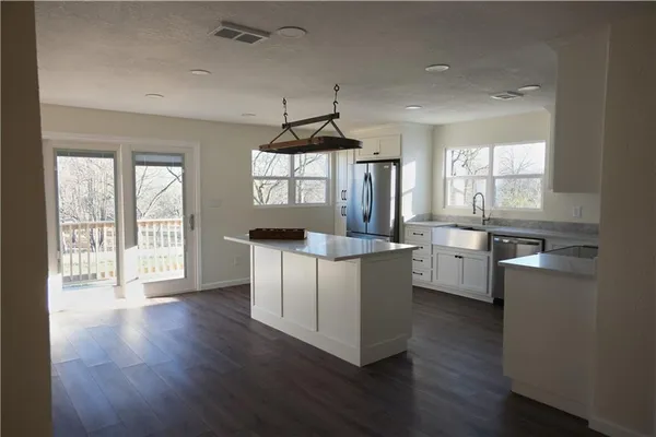a kitchen with counter top space a sink and appliances
