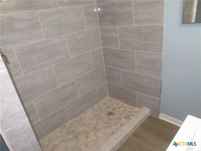 a utility room with a sink and mirror