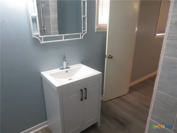 an empty room with wooden floor and closet