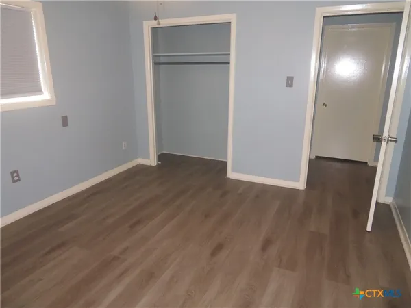 an empty room with wooden floor